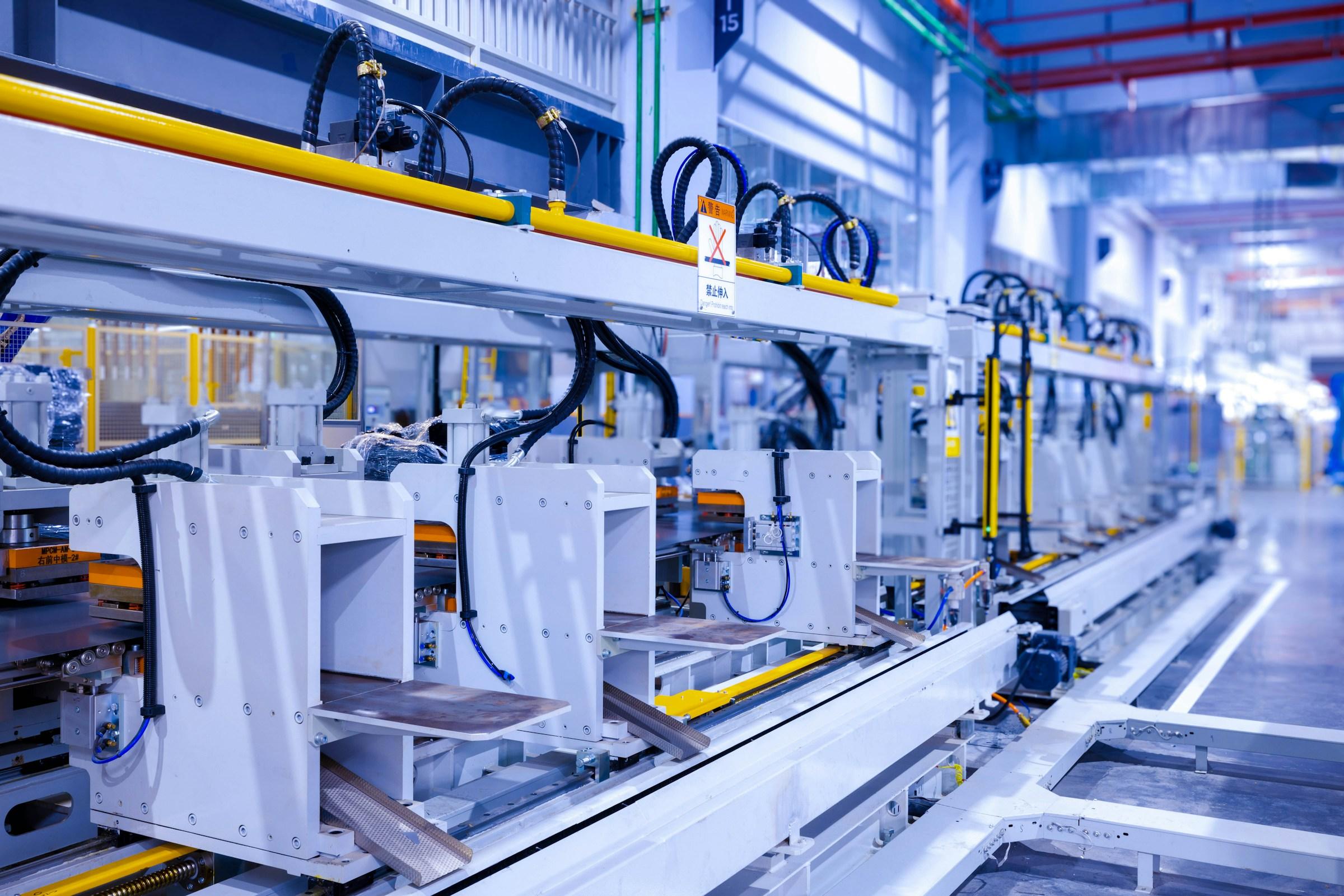 Automated production equipment along a refrigerator assembly line